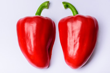 Two halves of red sweet pepper on a white background.