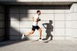 © Santi Nunez/Stocksy - Handsome man running in the city.