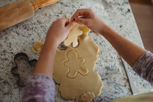 Overhead Of Girl With Gingerbread Cookie Cutout