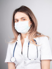 Wall Mural - A woman doctor at work in a hospital is excited and happy with her profession. Brunette woman doctor Concept of medicine and health care