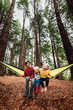 © Cavan Images - Three siblings in a hammock in New Zealand forest