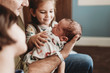 © Cavan Images - Close up side view of newborn boy and family in hospital with family