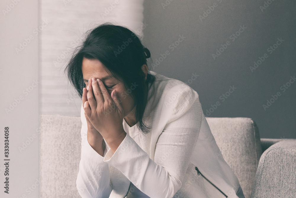 Coronavirus COVID-19 impact on retail businesses shut down causing unemployment financial distress. Depressed crying business woman stressed with headache. - obrazy, fototapety, plakaty 