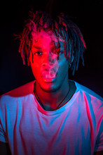 Portraits Of Beautiful African Young Man Under Blu And Red Lights