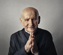Portrait Of Priest In Prayer Pose
