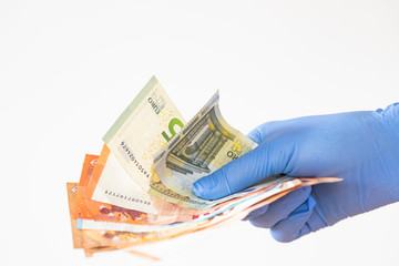 holding money with surgical gloves coronavirus protection