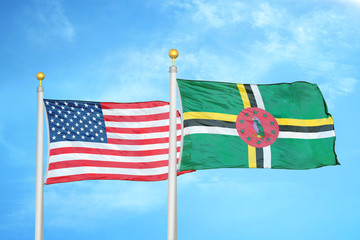 United States and Dominica two flags on flagpoles and blue cloudy sky