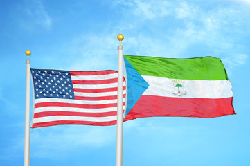 United States and Equatorial Guinea two flags on flagpoles and blue cloudy sky