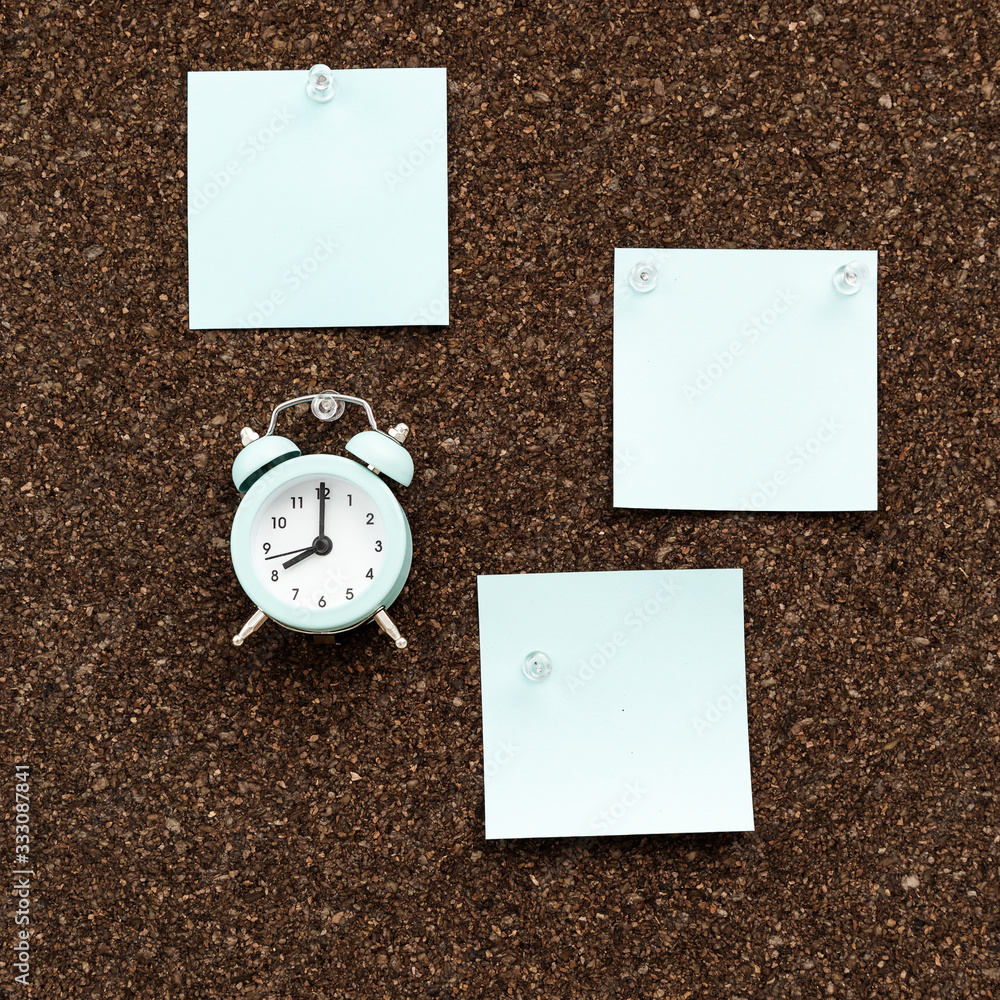 Bulletin-board with empty stickers for plans and clock for time control. Time tracking, reminders of meetings or events.