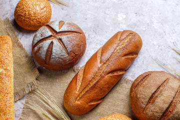 Wall Mural - Different kinds of fresh bread as background, top view