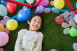 © lalalululala - asian child lying in colorful balls park playground