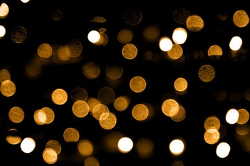 golden bokeh lights. Christmas glitter background. Abstract night golden color. New year circle element. Magic effect