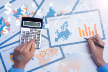 Wall Mural - Business analyst doing paperwork with financial analysis graphs using calculator for audit. Close-up of businesswoman looking through documents. Finance concept