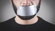 © andranik123 - Caucasian man with tape on mouth. Censorship