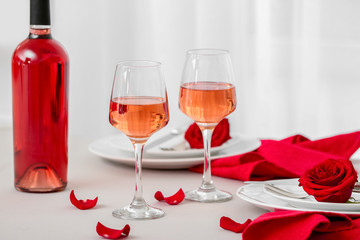 Glasses and bottle of wine on served table