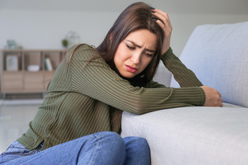 Poster - Depressed young woman at home