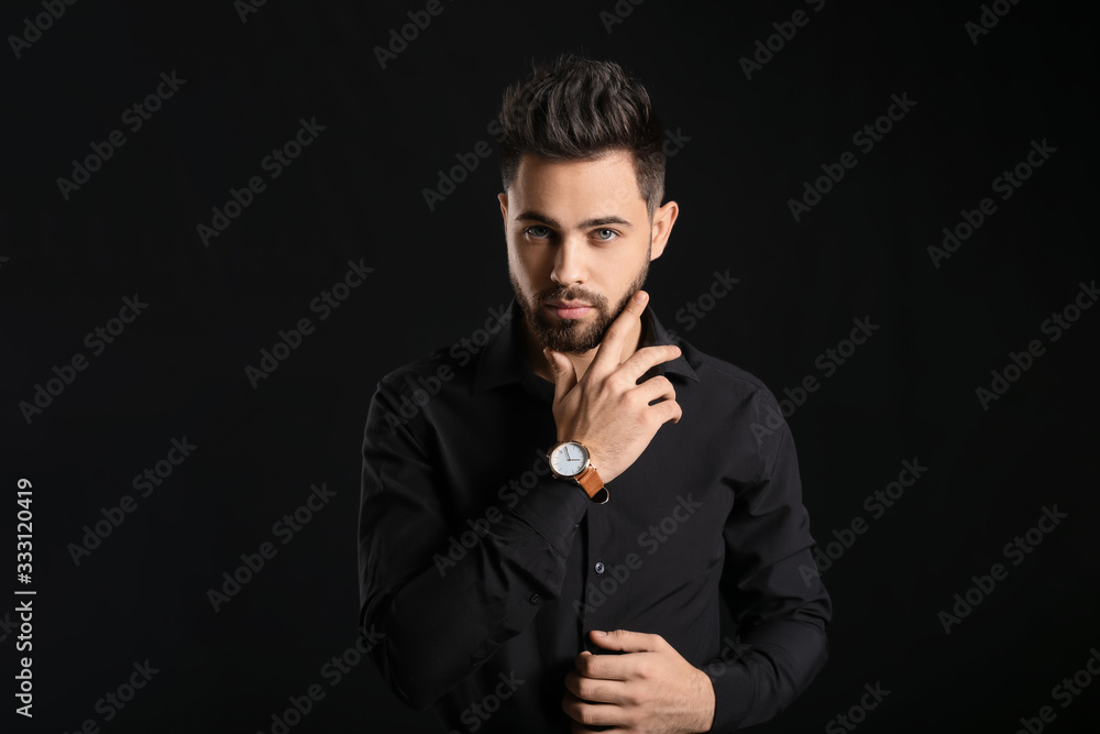 Handsome man with healthy hair on dark background