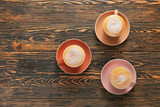 Fototapeta Mapy - Cups of hot coffee on wooden table