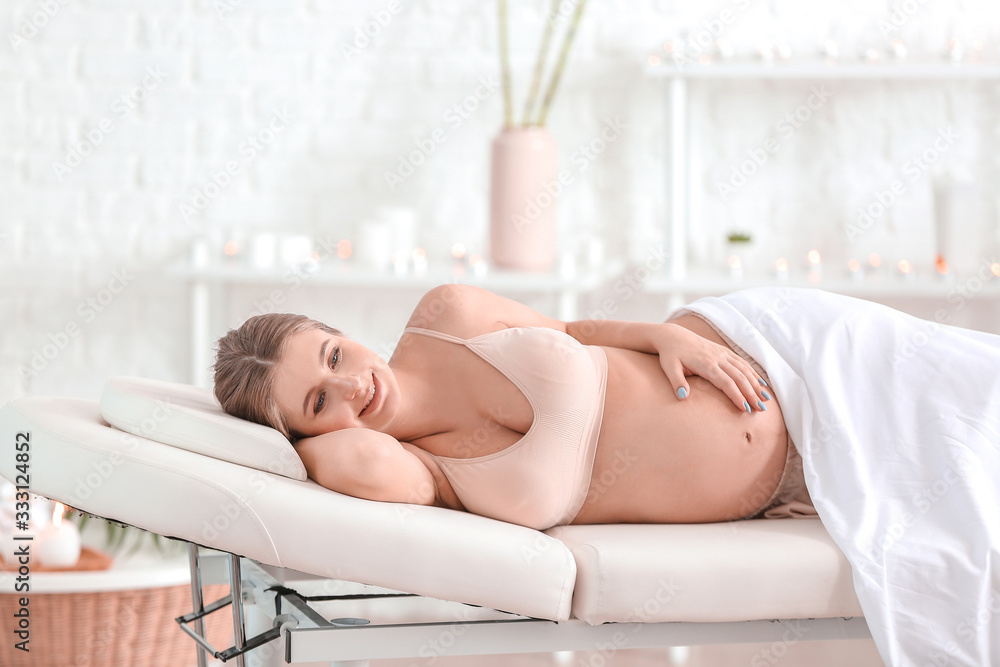 Young pregnant woman resting in spa salon