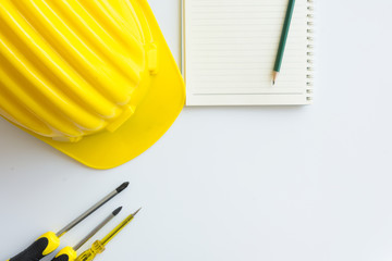 Yellow safety helmet with other on white table,copy space.