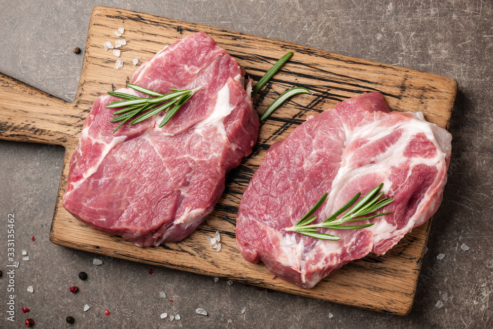 Raw pork steaks with rosemary and spices - obrazy, fototapety, plakaty 