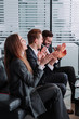 © newagecinema - Great job Successful business team is clapping their hands in modern workstation, celebrating the performance of new product
