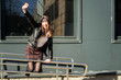 © Вячеслав Чичаев - Spring photo of a happy smiling beautiful girl with emotions in the sun outdoors on the background of the steps in the city. Model posing with hands in front of the camera.