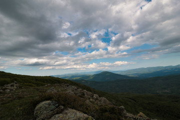 dramatic sky over hills and mountains in summer