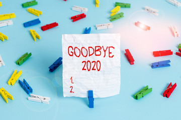 Canvas Print - Writing note showing Good Bye 2020. Business concept for express good wishes when parting or at the end of last year Colored clothespin papers empty reminder blue floor officepin