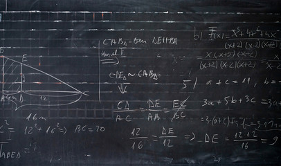 Wall Mural - Maths formulas written by white chalk on the blackboard background.