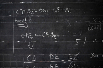 Wall Mural - Maths formulas written by white chalk on the blackboard background.