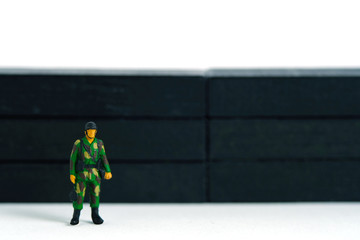  Pandemic coronavirus conceptual miniature people photography – Lockdown illustration – miniature soldier stand guard in front of barrier wall