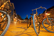Student bicycles on a square, Vismarkt, during blue hour in the city of Groningen, the Netherlands.
