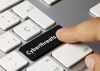 Wall Mural - cyberthreats - inscription on black keyboard key.
