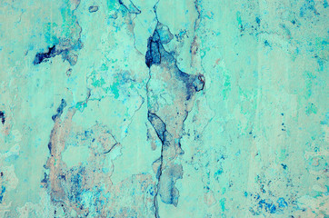 Blue background. Wall covered with old cracked stucco, tinted in classic blue. Bright neon backdrop. Modern urban industrial concept. Copy space. Selective focus image.