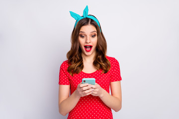 Wall Mural - Portrait of astonished excited girl use cell phone read incredible social media notification impressed scream wow omg wear stylish blue outfit isolated over grey color background