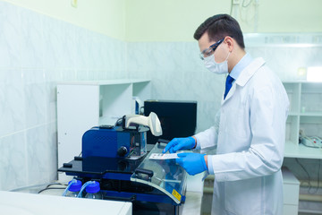 DNA laboratory. The expert puts the human DNA into the database using advanced laboratory technologies