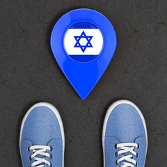 Poster - Travel to Israel Concept. Blue Denim Sneakers on the Asphalt Road with Map Pointer and Israel Flag Top View. 3d Rendering