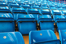 Empty Bleachers And Chairs In Blue