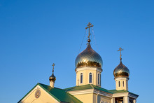 Eastern Orthodox Crosses On Gold Domes Cupolas Againts Blue Sky Without Clouds