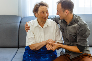 Grandson visiting grandmother at home in quarantine