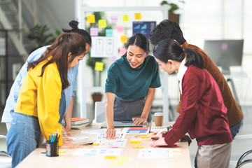 Young Asian woman leading business creative team in mobile application software design project. Brainstorm meeting, work together, internet technology, girl power, office coworker teamwork concept