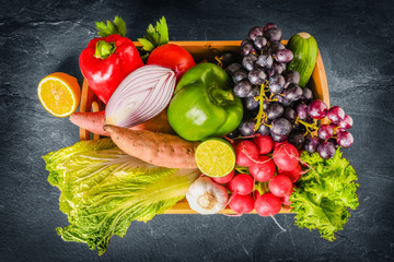 Wall Mural - Big collection of organic food. Fresh raw vegetables and citrus fruits. On a black background.