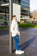 © Rafa Fernandez - Portrait of young male with hands on pocket leaning on pole outside
