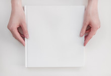 White Book Mockup. Square Empty Book. Album With Clean Pages In Hands Of Woman. Clean Book Cover Mockup