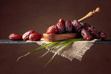 Wall Mural -  Closeup sweet dried dates in wooden dish.