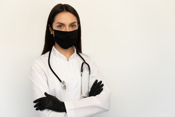 Wall Mural - Female doctor in black protective medical mask and black gloves, a stethoscope on neck