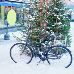 Wall Mural - Bicycle at Christmas tree in snowy street of winter Rovaniemi