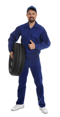 Sticker - Full length portrait of professional auto mechanic with wheel on white background