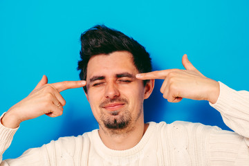 Closeup portrait of angry man gesturing with his finger against his temple, are you crazy?